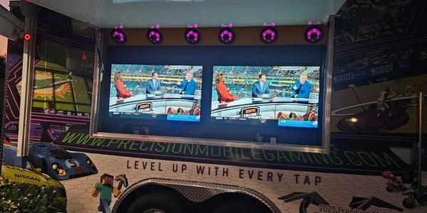 PMG truck exterior with dual ESPN screens showing live sports broadcast